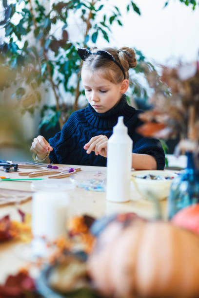 istock Little girl engaged in mosaic workshop. 1184894328