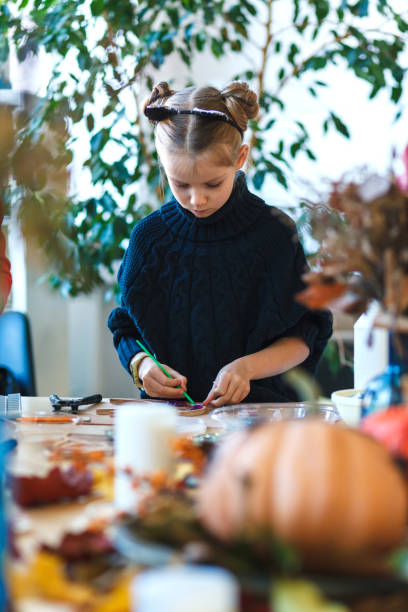 istock Little girl engaged in mosaic workshop. 1184894331
