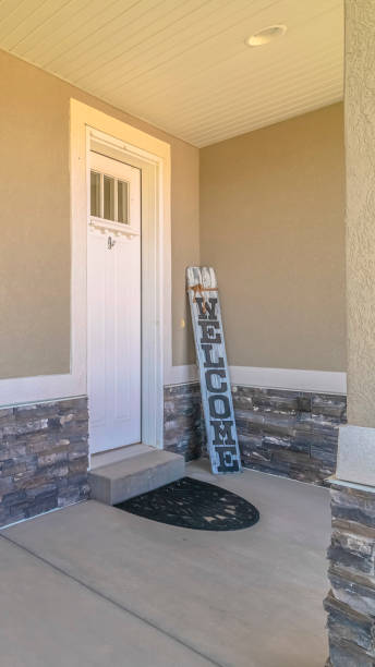 istock Vertical Front veranda of modern home with welcome sign 1184894366