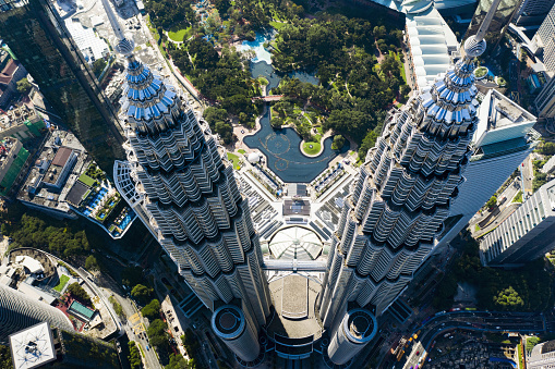 Aerial view of the Petronas Twin Towers with the KLCC Park in the background. The Petronas Towers are twin skyscrapers in Kuala Lumpur, Malaysia.