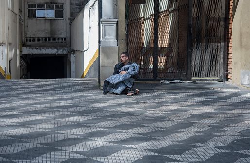 Sao Paulo, Brazil - December 12, 2015: Homeless man on the streets of Sao Paulo. In 2019, the government of Sao Paulo previews that more than 25.000 (twenty thousand) people live in the city streets