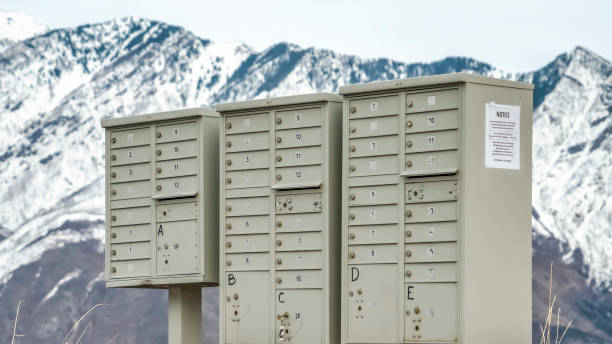 istock Panorama Mailboxes with compartments and numbers against snowy mountain and cloudy sky 1184894473