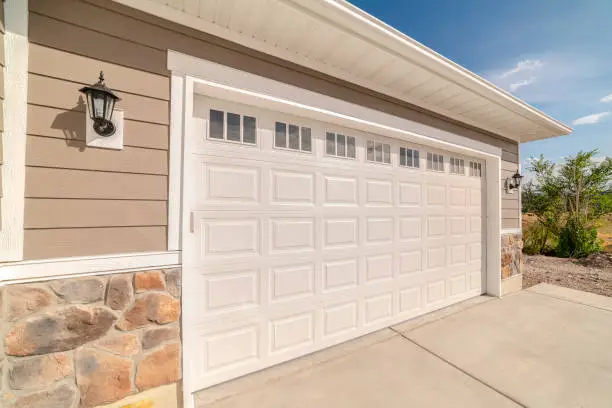 Double garage of modern home on sunny, clear day. A double garage and driveway of a modern home on a sunny, clear day.