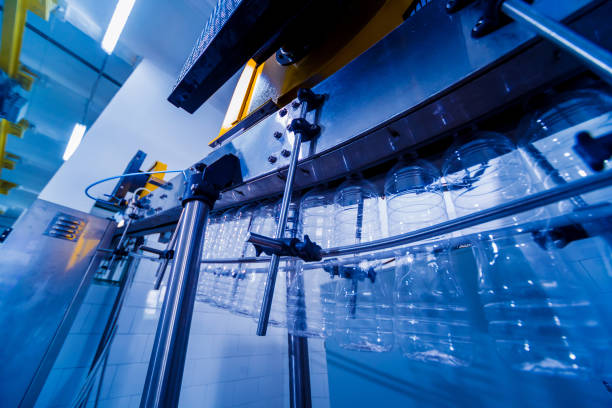 istock The plastic bottle blowing machine. PET preforms for blowing of plastic bottles. Heating process. 1184894914