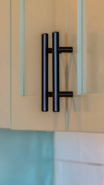 istock Vertical frame Close up of kitchen cupboards and black handles 1184895028