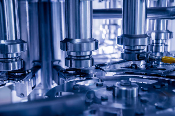istock Automatic filling machine pours water into plastic PET bottles. Brewing production. 1184895099
