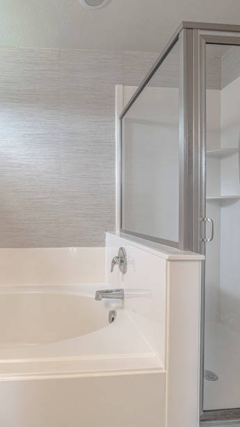 istock Vertical Contemporary bathroom and shower home interior in white 1184896278