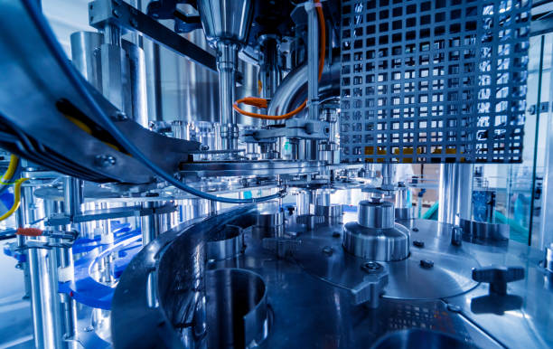 istock Automatic filling machine pours water into plastic PET bottles. Brewing production. 1184896370
