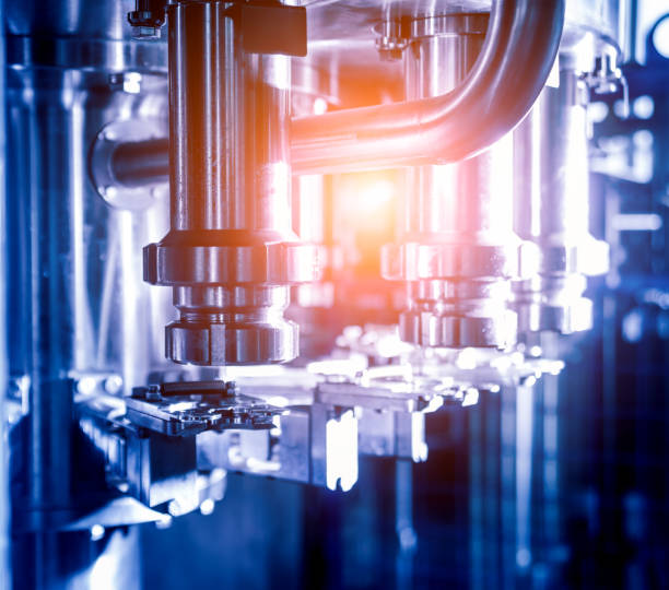 istock Automatic filling machine pours water into plastic PET bottles. Brewing production. 1184896472
