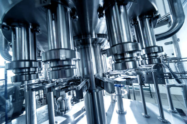 istock Automatic filling machine pours water into plastic PET bottles. Brewing production. 1184897283