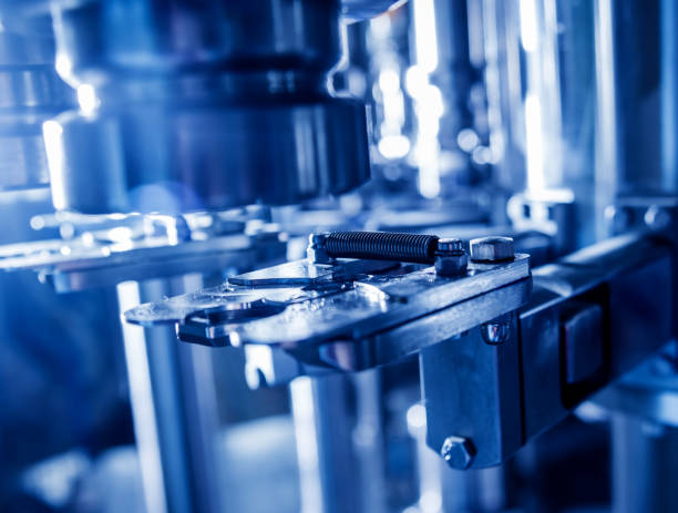 istock Automatic filling machine pours water into plastic PET bottles. Brewing production. 1184897422