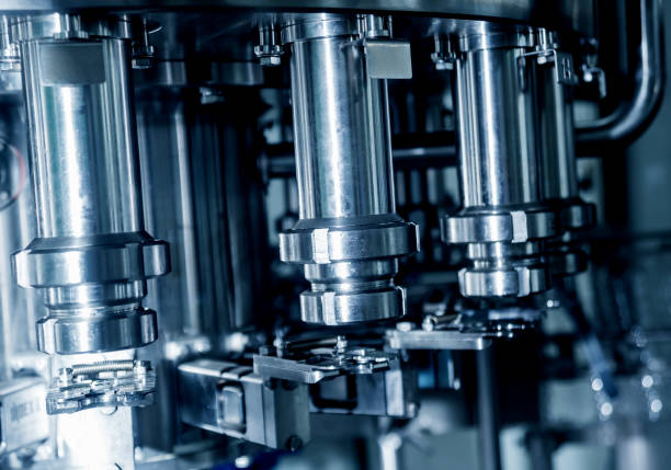 istock Automatic filling machine pours water into plastic PET bottles. Brewing production. 1184898475