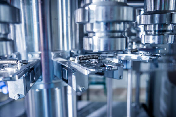 istock Automatic filling machine pours water into plastic PET bottles. Brewing production. 1184898516