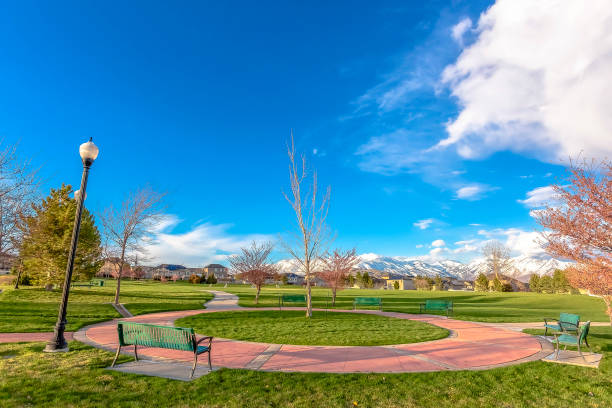istock Benches around a circular walkway in a park 1184898524