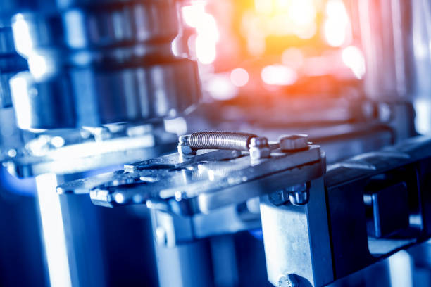 istock Automatic filling machine pours water into plastic PET bottles. Brewing production. 1184898704