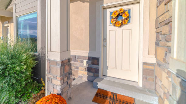 istock Panorama frame Front door of modern home with sunflower wreath 1184899070