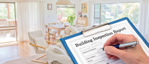 Banner Building Inspector completing an inspection form on clipboard stock photo