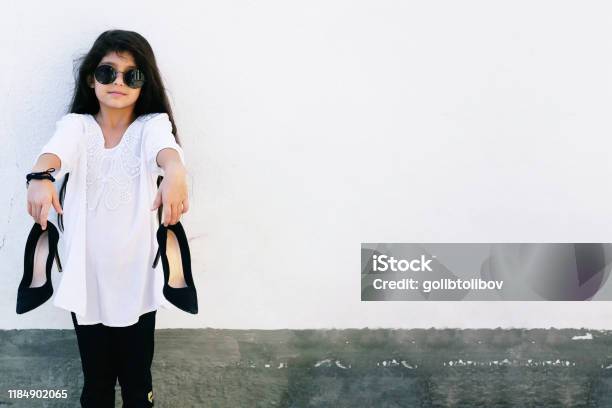 A Funny Little Fashionista With Black Highheeled Shoes A Pretty Little Girl In Eyeglasses Wearing A A Funny Little Fashionista With Black Highheeled Shoes A Pretty Little Girl In Eyeglasses Wearing A