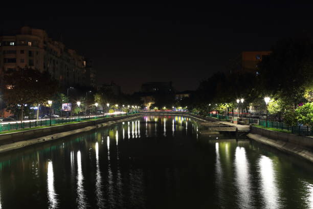 istock River at night in the city 1184902202