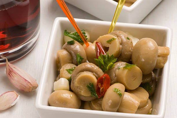 Spanish tapas. Garlic sizzled mushrooms. Champiñones al ajillo. stock photo