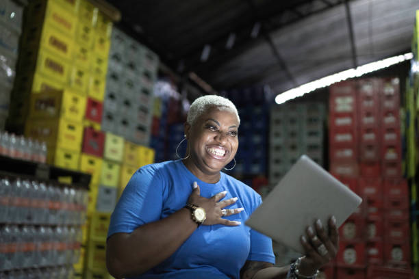 istock Surprised mature employee using digital tablet at warehouse 1184902595