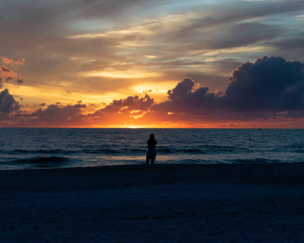 istock Photographer on Beach at Sunset 1184904552