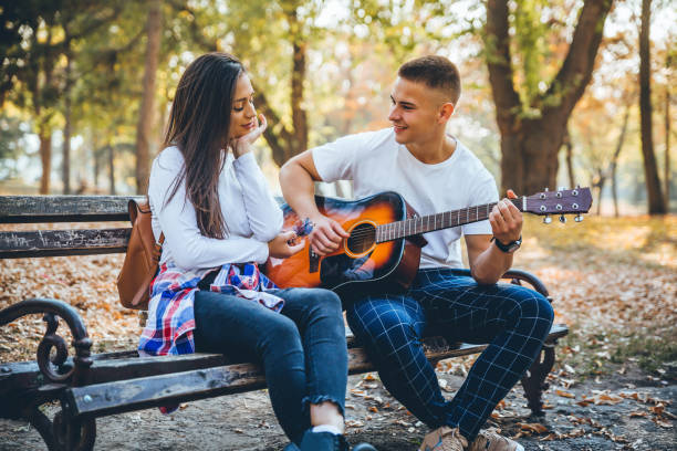 istock Young man playing a guitar to his girlfriend 1184908233