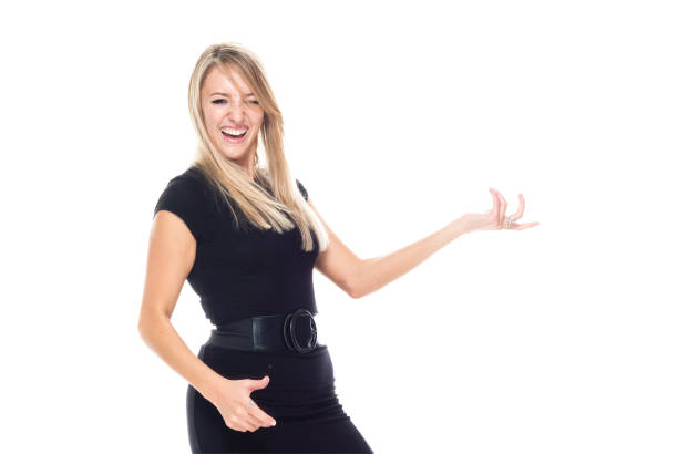 front view / looking at camera / one person / waist up of 20-29 years old adult beautiful blond hair caucasian female / young women rock musician / businesswoman / business person standing / bending / dancing wearing businesswear / dress / a suit - thank you excitement waist up horizontal imagens e fotografias de stock