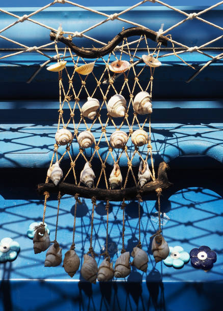 decor garland Mediterranean design seashells small on the fishing line on a blue background focus in the center of the frame