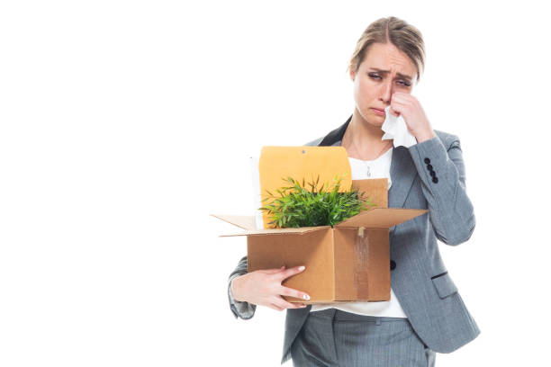 One person / front view / waist up of 20-29 years old adult beautiful caucasian female / young women businesswoman / business person standing in front of white background wearing a suit who is feeling sad / depression - sadness / unemployed / bankrupt / disappointed / displeased / unemployed who is moving office and holding box - container / cardboard box / being fired una persona / vista frontal / cintura para arriba de 20-29 años de edad adulto hermosa mujer caucásica / mujer de negocios joven / persona de negocios de pie frente a fondo blanco usando un traje que está moviendo la oficina y la caja de retención - co
