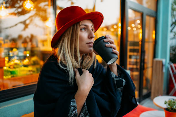 istock Woman Drinking Coffee in Reusable Cup 1184909730