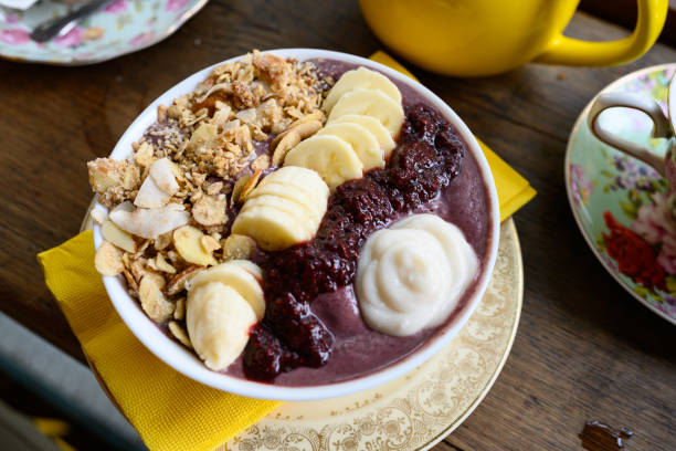 Gormet Acai Bowl Topped with Granola Fruit and Dairy Free Yogurt This is a photograph of a vegan açaí bowl served with granola, fruit and non dairy yogurt in Brooklyn, New York. Acai Bowl stock pictures, royalty-free photos & images