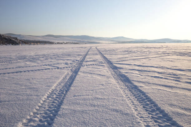 Wheel tracks on the winter road covered with snow. stock photo