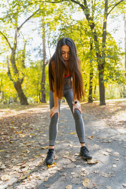 istock Beautiful woman making a break during her run 1184912663
