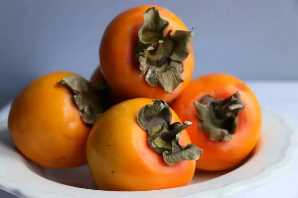 Istanbul, Turkey-November 1, 2019: Persimmon on plate