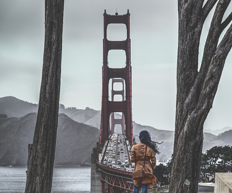 Woman traveler stops by Golden Gate Bridge to take in the view