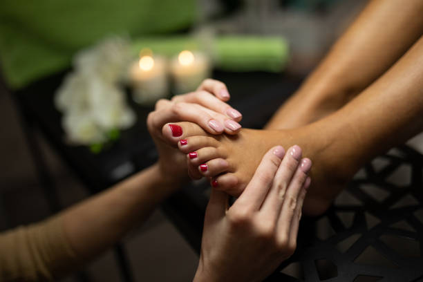 Relaxing foot massage in beauty spa stock photo