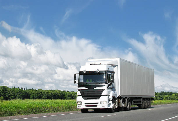 istock white truck on highway under blue sky 118491696
