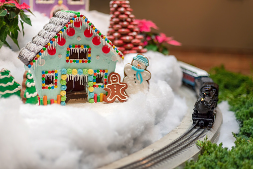 Toy train and brightly colored gingerbread house - holiday background