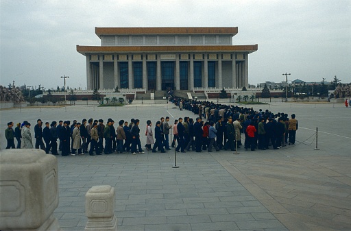 Beijing, People's Republic of China, 1985. Chinese people standing in a row in front of Mao's mausoleum.