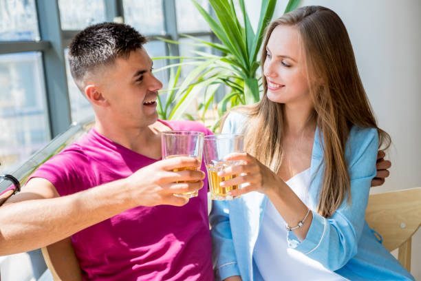 istock Cheerful couple in the pub. Drinking beer, talking, having fun. 1184923315