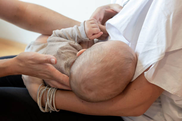 istock Osteopath doing theraphy on baby during breastfeeding 1184925531