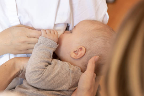 istock Osteopath doing theraphy on baby during breastfeeding 1184925539