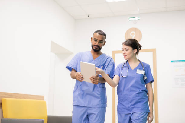 istock One of two clinicians making presentation or explaining something to colleague 1184925791