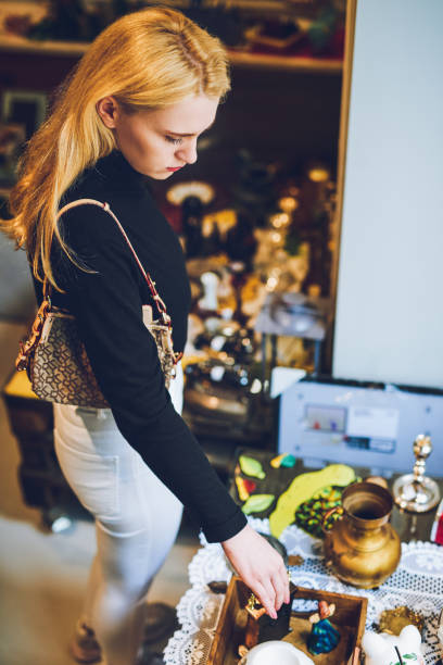 Shot of a young woman shopping for antique goods at a store
