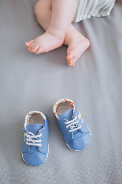 istock little baby feet bed delicate textile conceptual 1184929421