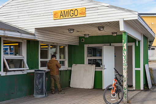 Sisimiut, Greenland - August 17, 2019: A local inuit customer at the bar - restaurant Amigo in Sisimiut, Greenland.