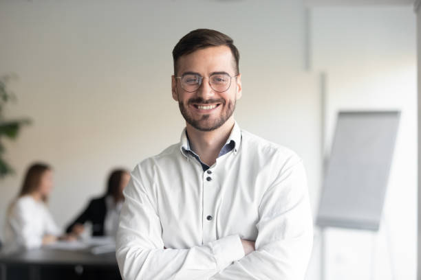 istock Confident smiling businessman professional coach looking at camera in office 1184930440