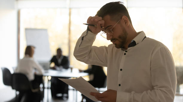Stressed sweaty inexperienced speaker reading speech feeling public speaking fear