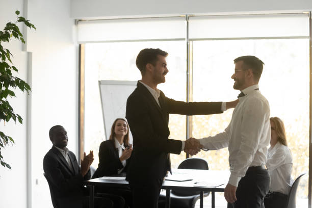 istock Helpful proud boss handshaking praising male worker express appreciation 1184930458